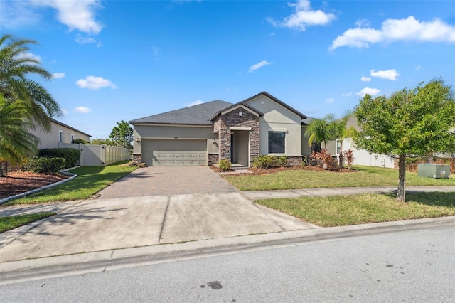 view of front of property featuring a front yard and a garage