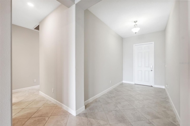 hall featuring light tile patterned floors