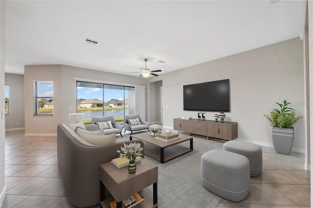 tiled living room with ceiling fan