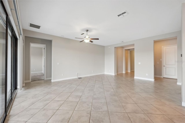 tiled spare room with ceiling fan