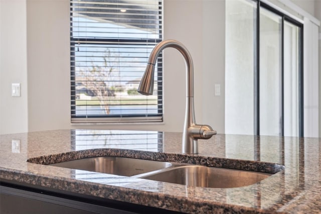 details featuring sink and dark stone counters