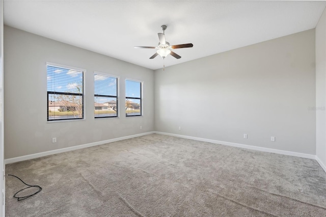 carpeted empty room featuring ceiling fan