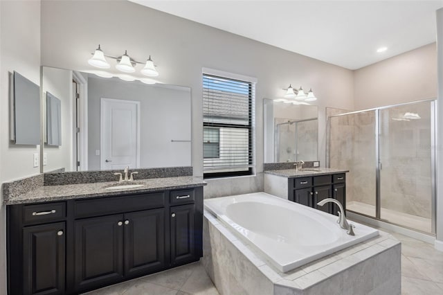 bathroom featuring vanity, shower with separate bathtub, and tile patterned flooring