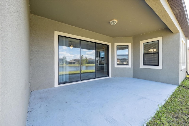 property entrance featuring a water view and a patio