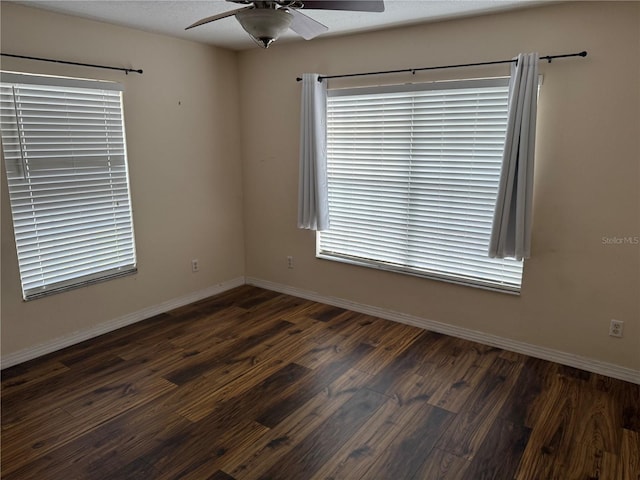 empty room featuring a textured ceiling, dark hardwood / wood-style floors, and ceiling fan