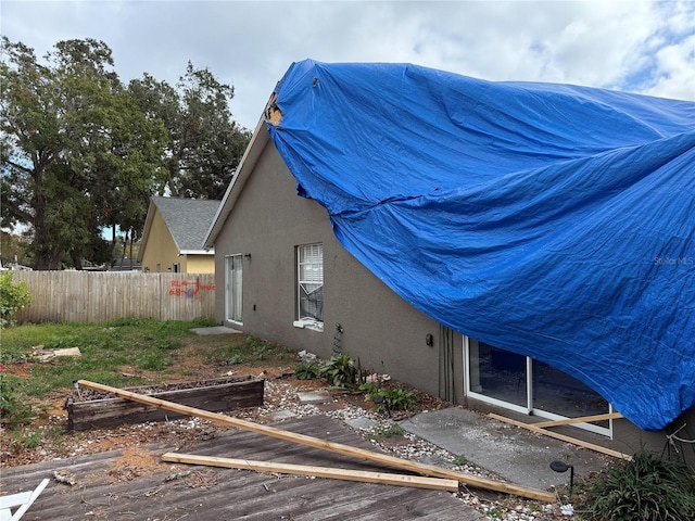 view of property exterior with a wooden deck