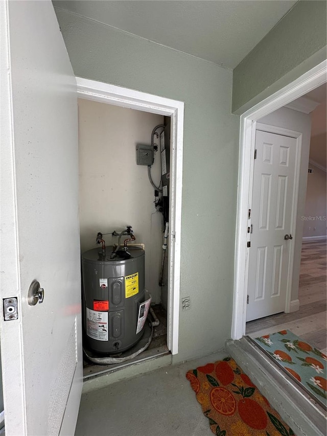 utility room featuring water heater