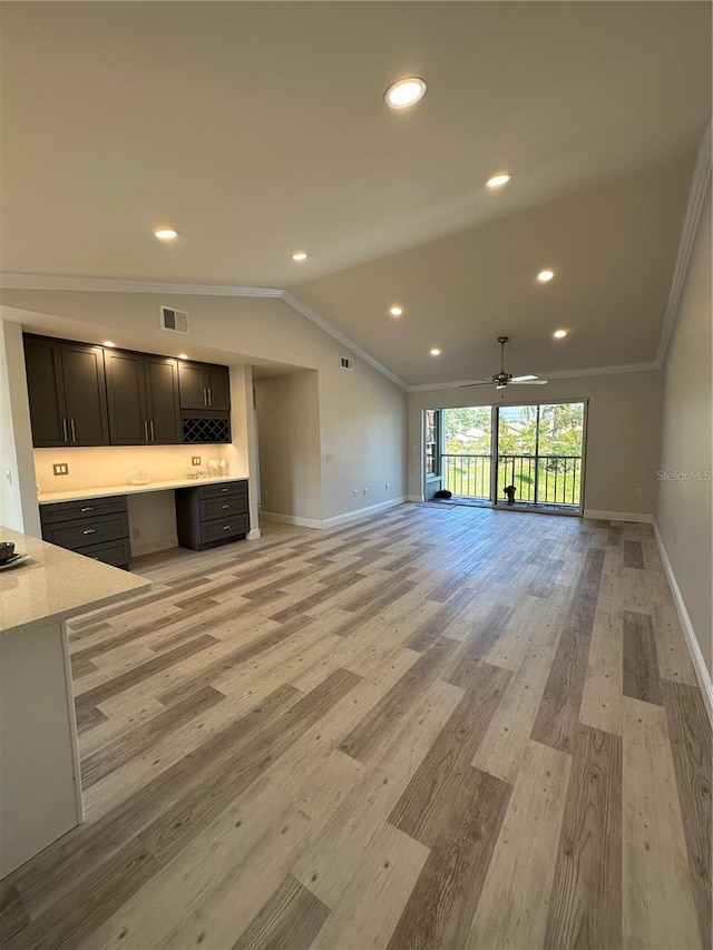 unfurnished living room featuring light hardwood / wood-style flooring, ornamental molding, built in desk, and ceiling fan