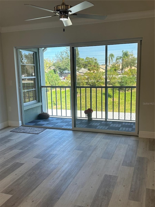 entryway with ceiling fan, ornamental molding, and hardwood / wood-style floors