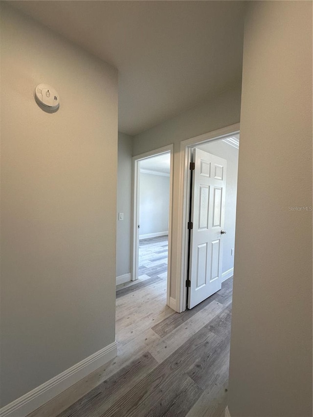 corridor with light hardwood / wood-style floors