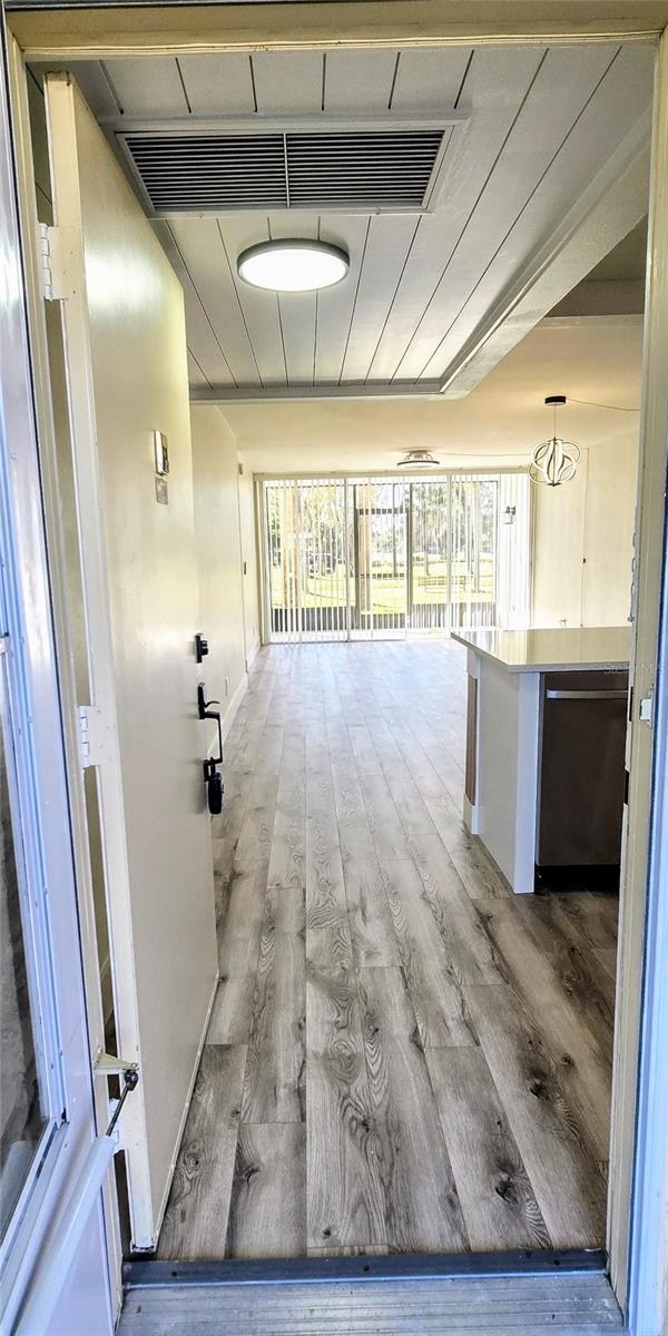 corridor with light hardwood / wood-style floors