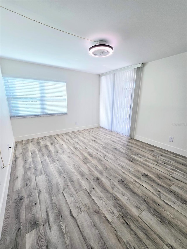 unfurnished room with light hardwood / wood-style floors