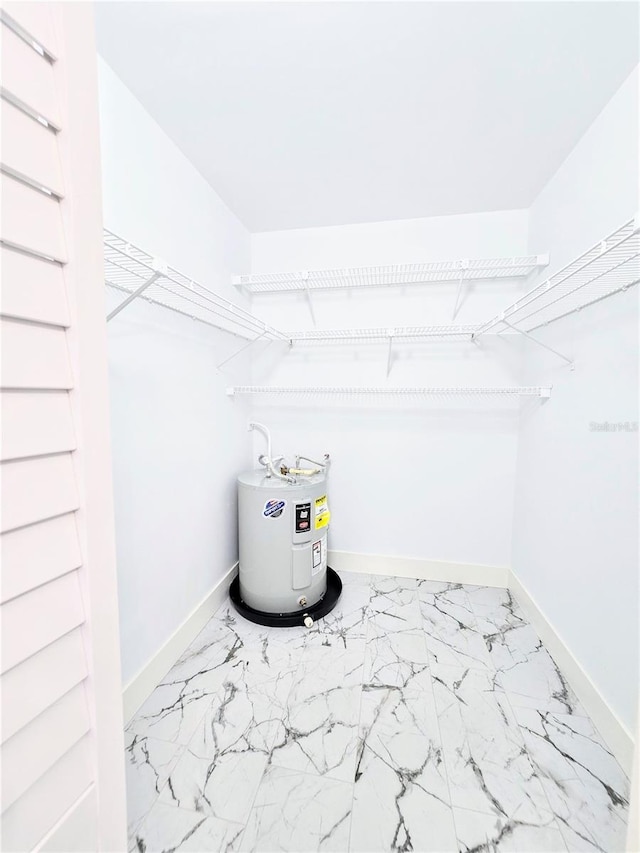 walk in closet featuring electric water heater