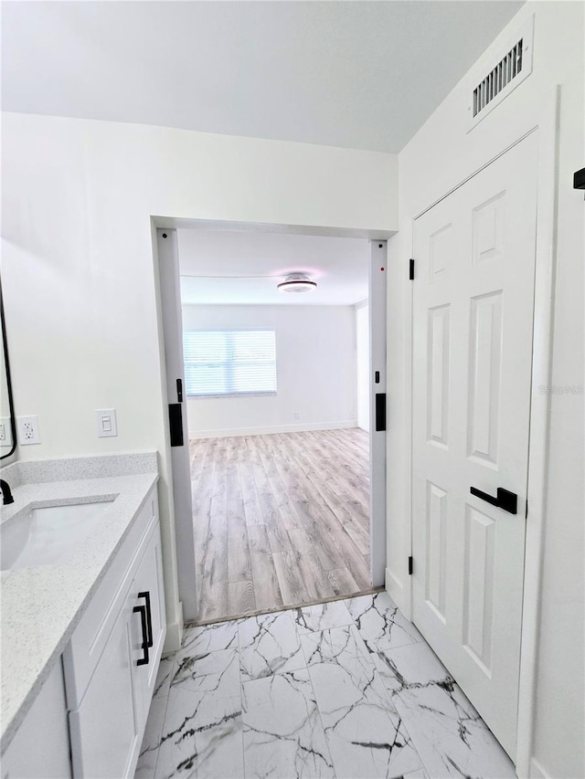 bathroom featuring vanity and hardwood / wood-style floors