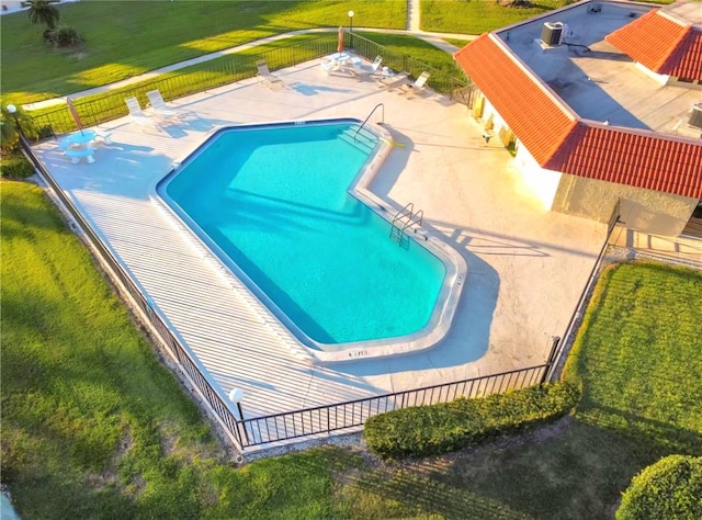 view of swimming pool with a patio and a yard