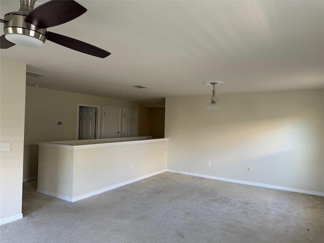 unfurnished room with light colored carpet and a textured ceiling