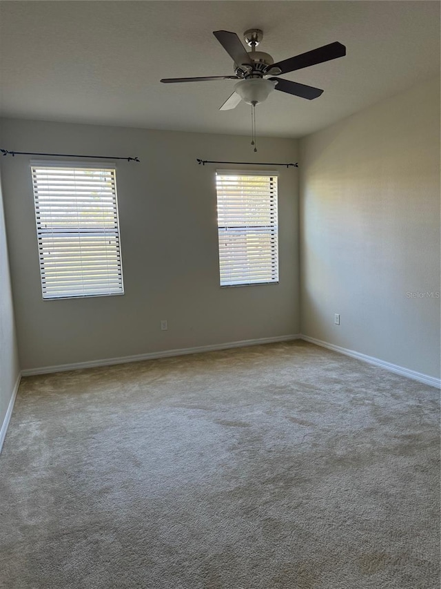 carpeted empty room with ceiling fan