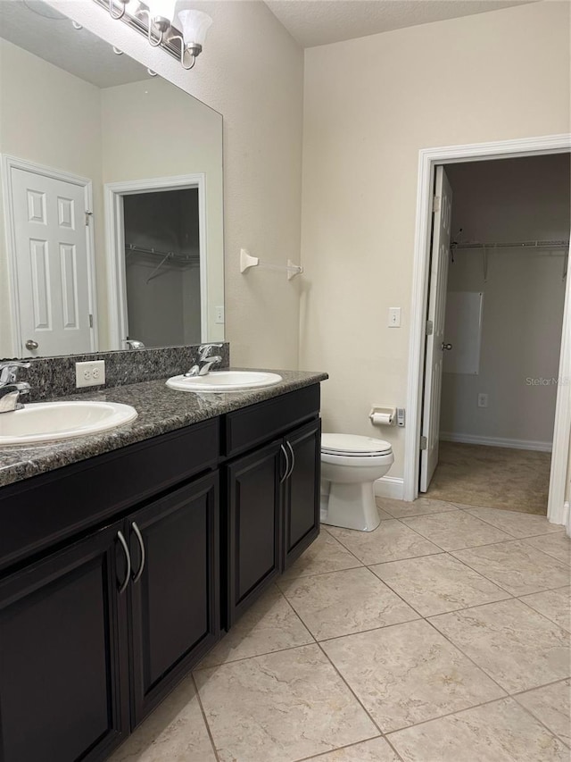 bathroom with vanity, tile patterned floors, and toilet