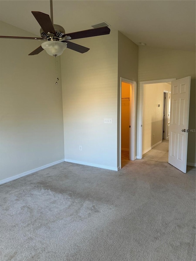 carpeted empty room with high vaulted ceiling