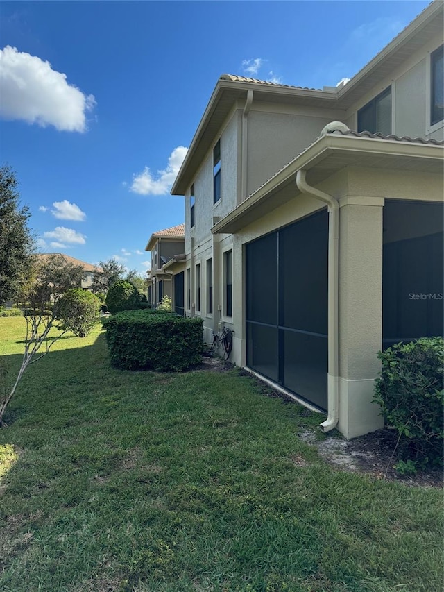 view of property exterior with a lawn