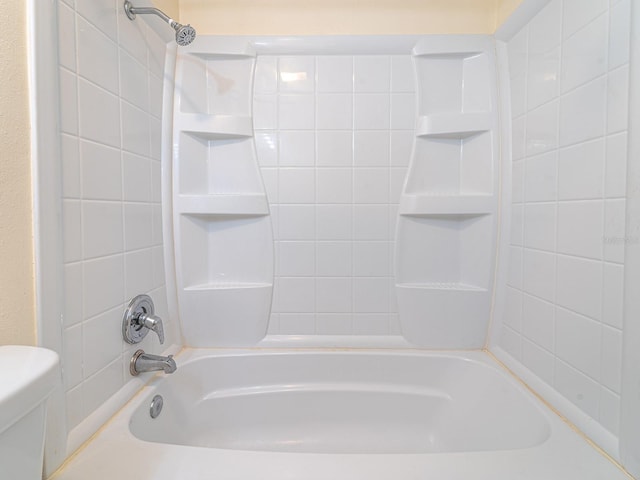 bathroom featuring toilet and bathing tub / shower combination