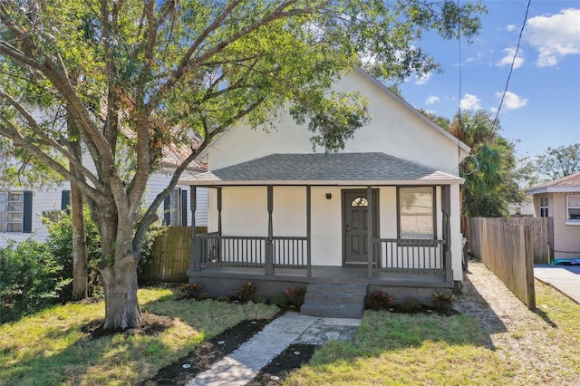 bungalow-style house featuring a front lawn and a porch