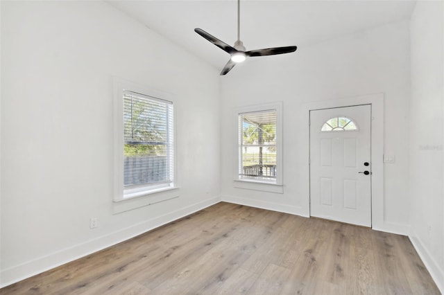 entryway with light hardwood / wood-style flooring, ceiling fan, plenty of natural light, and vaulted ceiling