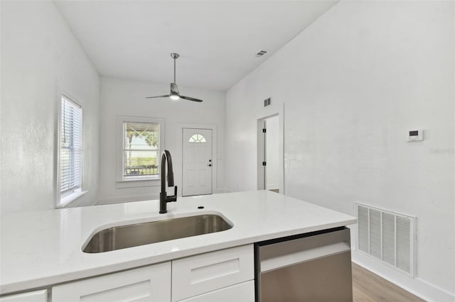 kitchen featuring light hardwood / wood-style flooring, sink, stainless steel dishwasher, white cabinetry, and ceiling fan