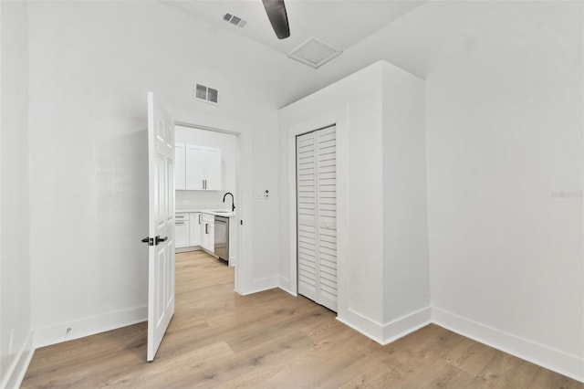 hallway featuring sink and light wood-type flooring