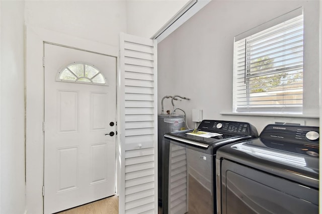 laundry area featuring washer and dryer and light wood-type flooring