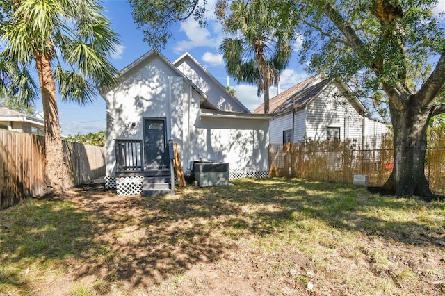 rear view of house with a yard