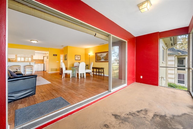 interior space with a wealth of natural light and hardwood / wood-style flooring