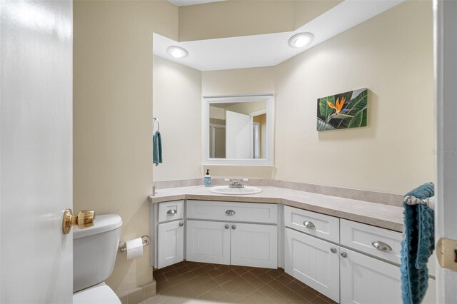 bathroom with vanity, toilet, and tile patterned flooring