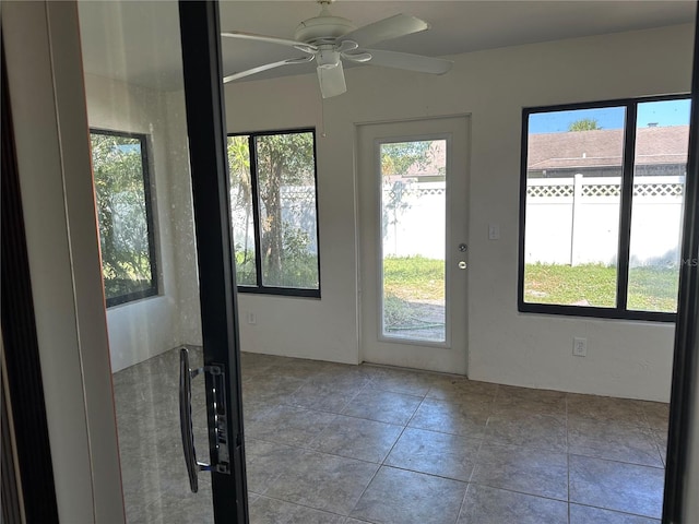 doorway to outside featuring light tile patterned floors and ceiling fan