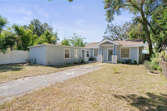 single story home with a front lawn and central air condition unit