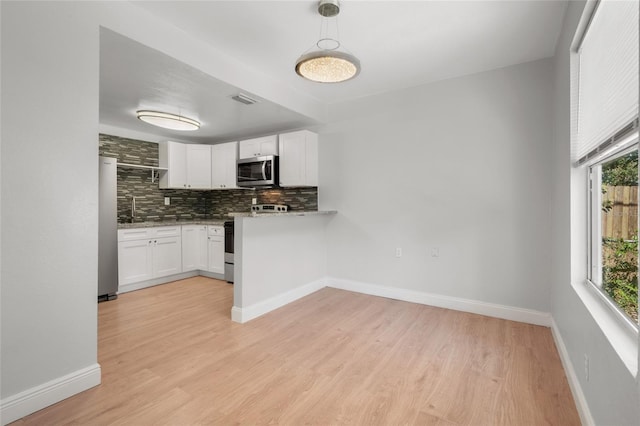 kitchen with white cabinetry, appliances with stainless steel finishes, and plenty of natural light