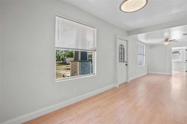 unfurnished room with light hardwood / wood-style flooring and ceiling fan