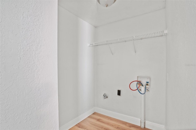 clothes washing area featuring hookup for a washing machine, wood-type flooring, and hookup for an electric dryer