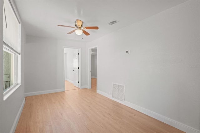 spare room with light hardwood / wood-style flooring and ceiling fan