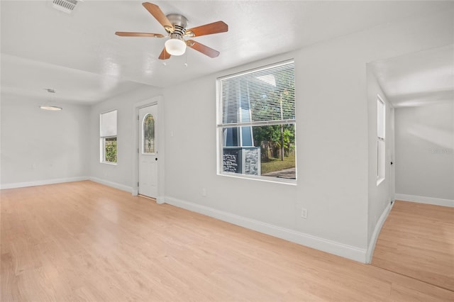 empty room featuring light hardwood / wood-style flooring and ceiling fan