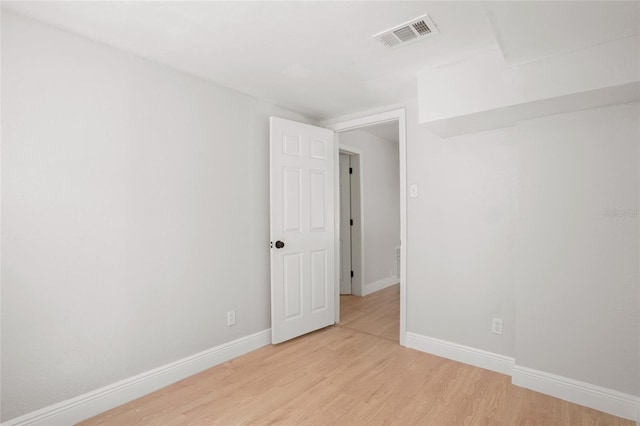 spare room with light hardwood / wood-style flooring