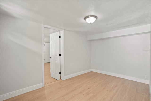 basement with a textured ceiling and light wood-type flooring