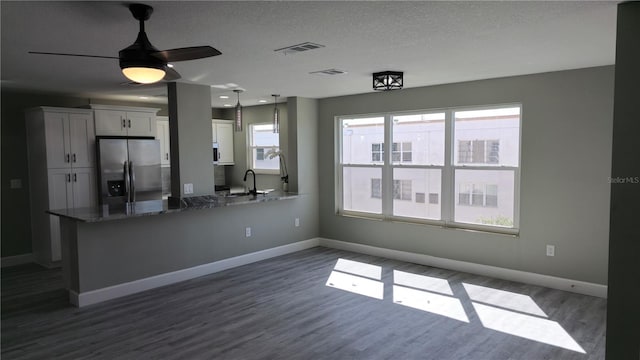 5623 80th St N Unit 510, Saint Petersburg, FL 33709 - kitchen with stainless steel fridge with ice dispenser, a sink, dark wood-type flooring, baseboards, and a textured ceiling