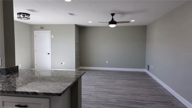 5623 80th St N Unit 510, Saint Petersburg, FL 33709 - kitchen with recessed lighting, ceiling fan, dark wood finished floors, baseboards, and dark stone counters