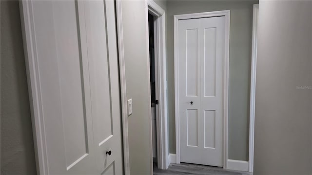 corridor with wood-type flooring