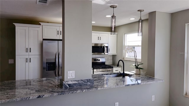 5623 80th St N Unit 510, Saint Petersburg, FL 33709 - kitchen with stainless steel appliances, a sink, white cabinetry, stone counters, and recessed lighting