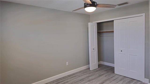 5623 80th St N Unit 510, Saint Petersburg, FL 33709 - unfurnished bedroom with light wood finished floors, baseboards, a closet, and a ceiling fan