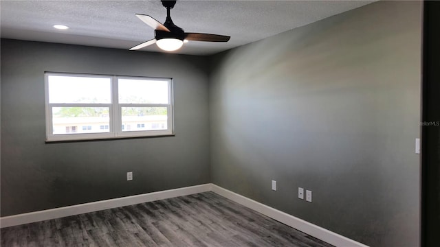 empty room featuring a textured ceiling, wood-type flooring, and ceiling fan