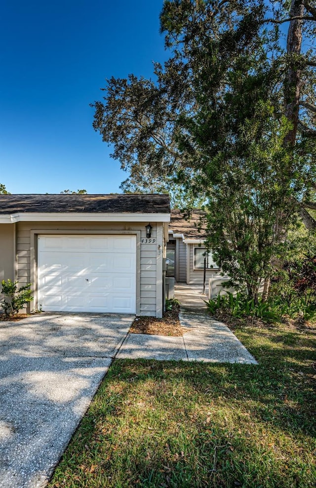 view of front of home with a front lawn and a garage