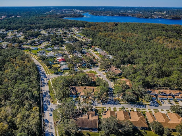 bird's eye view with a wooded view, a water view, and a residential view